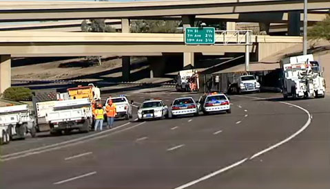  semi truck crashed and rolled over then spilled a load of coffee creamer all over the roadway on Interstate 10 in Phoenix, AZ on February 13, 2013.