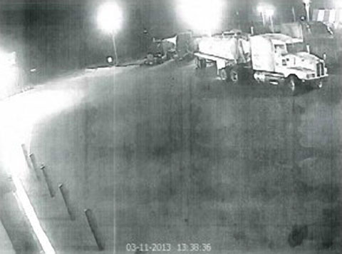 Surveillance camera image of a white Kenworth semi truck with vacuum tanker trailer that pulled out onto Texas Highway 44 and struck Luis David Wiles on March 12, 2013. Wiles was riding on a bicycle on the shoulder of the road at the time and suffered a broken leg in the accident. Photo credit ofelia.hunter@aliceechonews.com