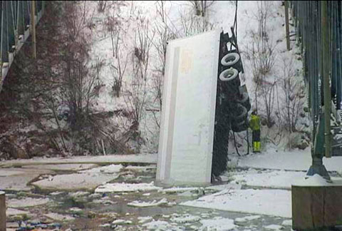 A trucker was killed when his semi truck plunged into the Red Cedar River off the westbound I-94 in Menomonie, WI on March 5, 2013 in snow covered conditions. Photo credit: WEAU-TV