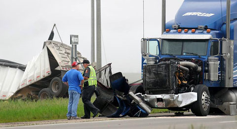 Two semi trucks were severely damaged in a collision on U.S. Highway 14 at State Highway 60 just outside Mankato, MN on June 10, 2013. Photo credit: John Cross / Mankato Free Press