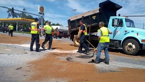 The fuel tank of a semi truck was ruptured causing a fuel spill after a car ran a red light and crashed into it in Rogers, AR on June 13, 2013. Photo credit: KNWA News 